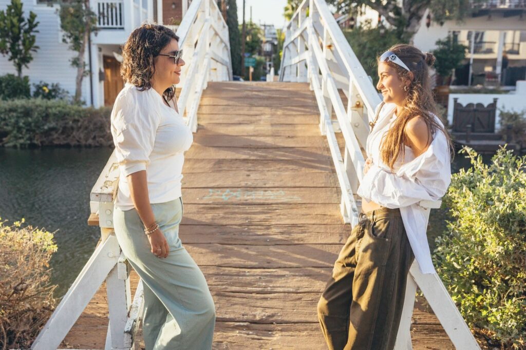 mother and daughter smiling during a photo session in Venice Canals, California