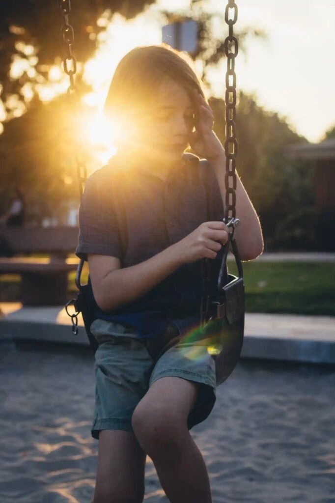 young boy in the golden light during a family photo session in mar vista recreation center